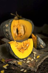 Close-up of yellow pumpkin against black background