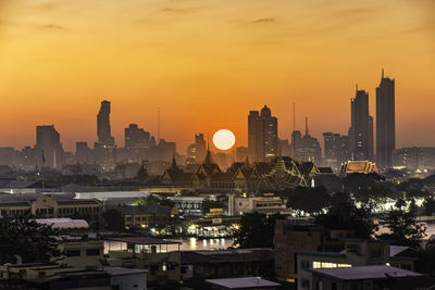 View of buildings in city during sunset