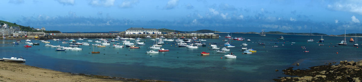 High angle view of sailboats moored on sea against sky