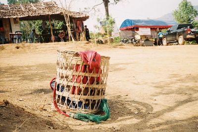 Wicker basket on beach against buildings