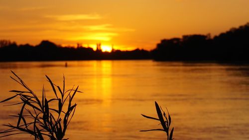 Scenic view of lake against romantic sky at sunset