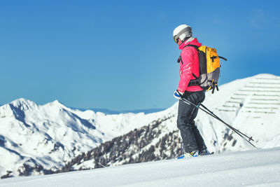 Rear view of man skiing on snow covered mountain