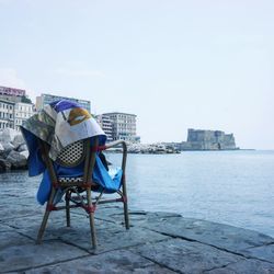 Chairs on beach against clear sky