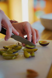 Cropped hand of person preparing food