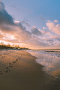 Scenic view of beach against sky during sunset