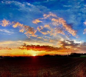 Scenic view of field against sky during sunset