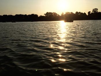 Scenic view of lake against sky during sunset