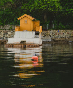 Small yellow colorful house and wharf in oslo fjord in norway. oslo fjord shore and scandic houses