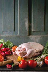 Close-up of vegetables and chicken meat on table