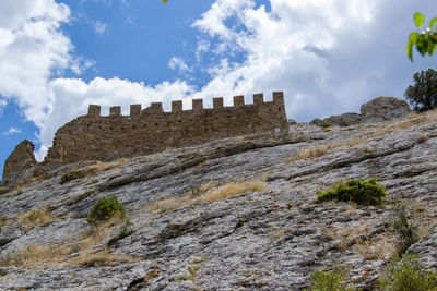 Low angle view of old ruins against sky