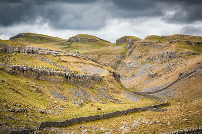 Scenic view of limestone formation against dramatic sky