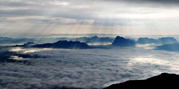 Scenic view of mountains against cloudy sky