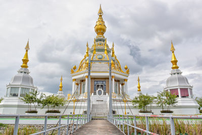 View of temple building against cloudy sky