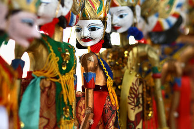 Close-up of multi colored wooden puppets at store