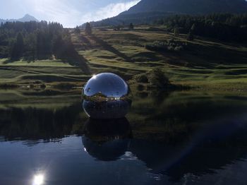 Scenic view of lake and mountains against sky