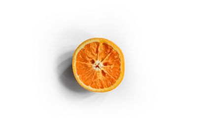 Close-up of orange slice against white background