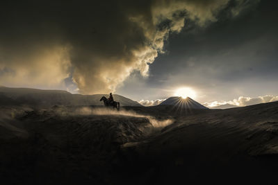 Scenic view of silhouette land against sky during sunset