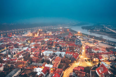 Aerial view of illuminated city buildings at night