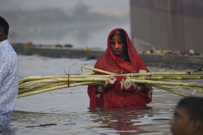 Portrait of woman with arms raised in water