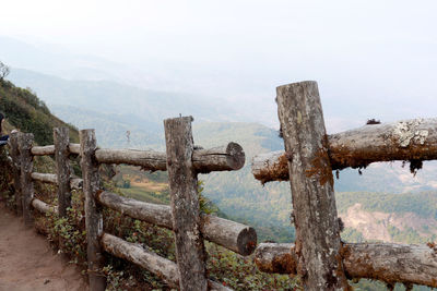 Fence on landscape against sky