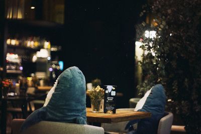 Low section of people sitting on table at restaurant