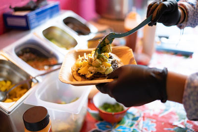 Cropped hand of man preparing food