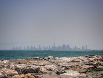 Scenic view of sea and buildings against sky