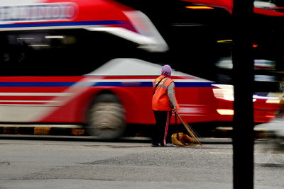 Rear view of people on road in city