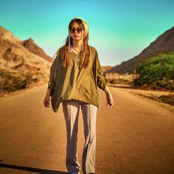 Full length of woman standing on road