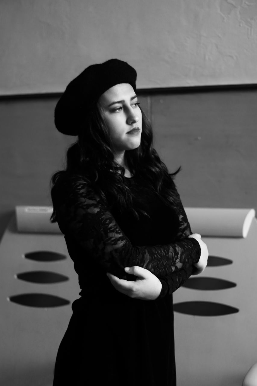 black, one person, clothing, adult, women, white, fashion, black and white, young adult, hat, standing, monochrome, portrait, monochrome photography, photo shoot, three quarter length, indoors, female, looking, lifestyles, waist up, long hair, hairstyle, person, dress, arts culture and entertainment, elegance, looking away, jacket
