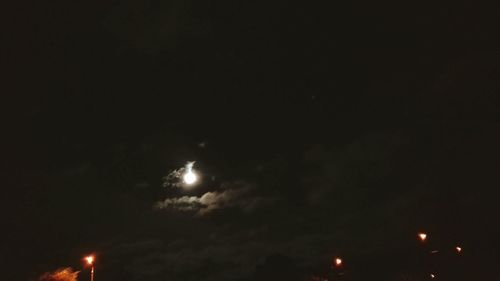 Low angle view of illuminated moon at night