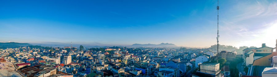 High angle view of city against blue sky