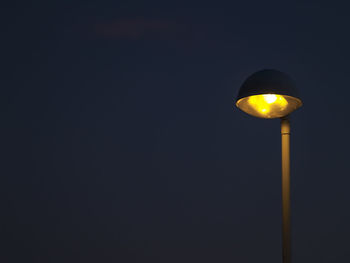 Low angle view of illuminated yellow lights against sky