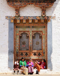 Rear view of people on wall of building