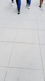 Low section of people on tiled floor