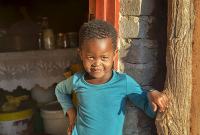 Portrait of smiling boy standing outdoors