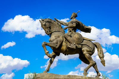 Low angle view of statue against sky