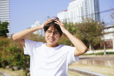 Portrait of smiling woman standing in city