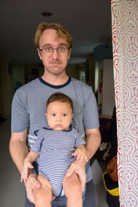 Portrait of father with son at home