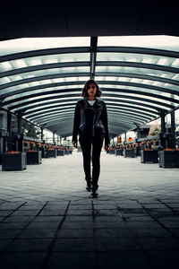 Portrait of woman standing on railroad station platform