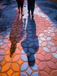 Low section of people walking on street