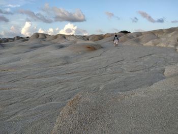 Full length of man on sand at beach against sky