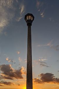 Low angle view of tower against cloudy sky