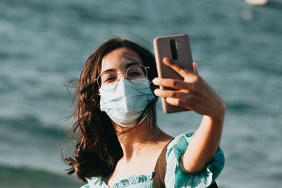 Portrait of young woman using mobile phone