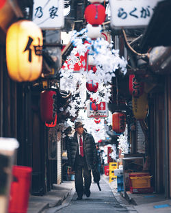 Full length of man standing in illuminated city