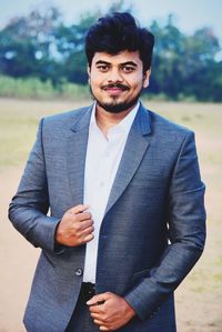 Portrait of young man standing outdoors