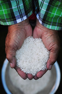 Close-up of man holding rice