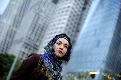 Portrait of beautiful young woman in city