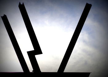 Low angle view of communications tower against sky