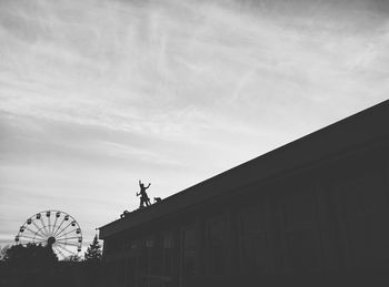 Low angle view of statue against sky in city